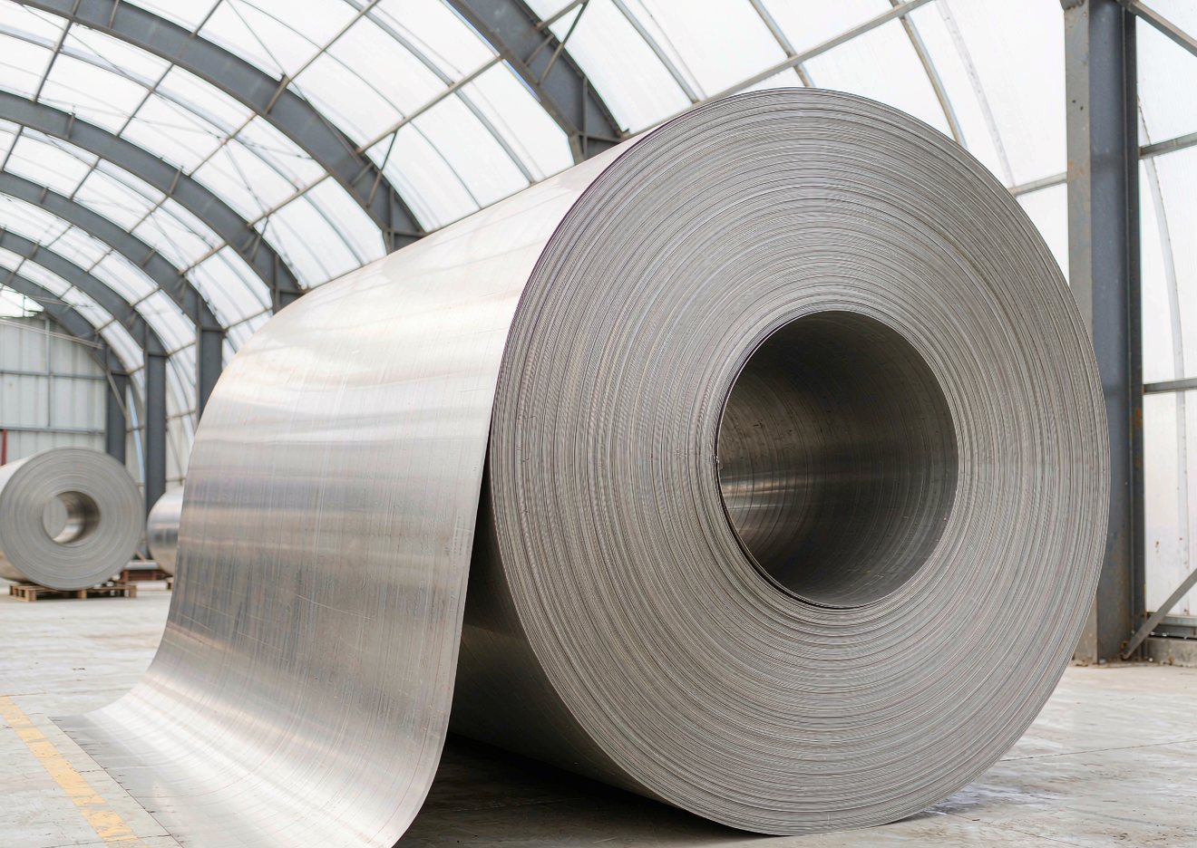 Rolled stainless steel coil in a bright warehouse